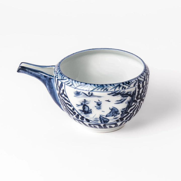 Porcelain sake pourer with spout featuring hand-painted indigo landscape and arabesque patterns in a traditional Japanese style.