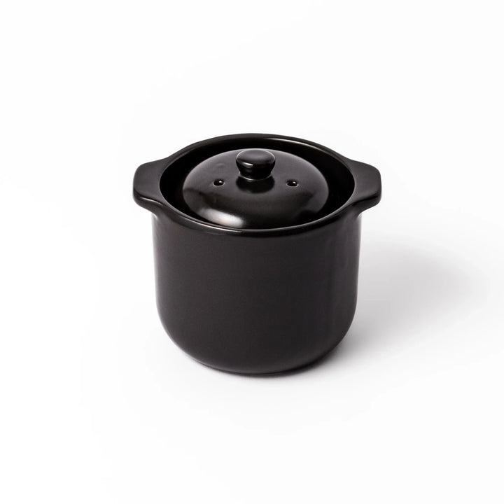 Black ceramic microwave rice cooker with double lid and side handles, designed for convenient cooking and serving at the table.