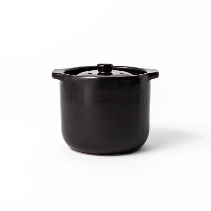 Black ceramic microwave rice cooker with double lid and side handles, designed for convenient cooking and serving at the table.