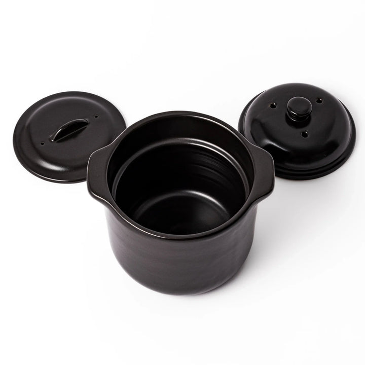 Black ceramic microwave rice cooker with double lid and side handles, designed for convenient cooking and serving at the table.