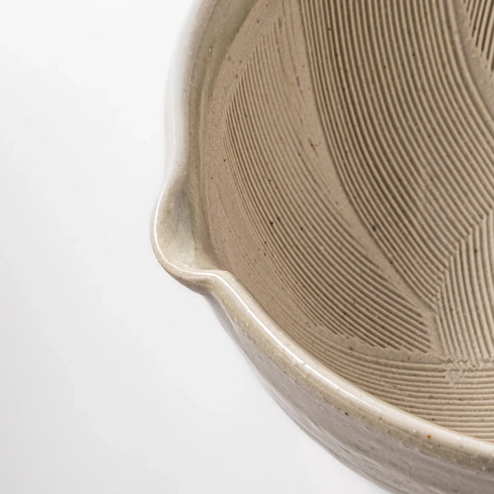 Celadon green Japanese suribachi mortar with finely grooved interior and pouring spout, perfect for grinding sesame seeds and preparing traditional sauces.