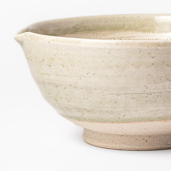 Celadon green Japanese suribachi mortar with finely grooved interior and pouring spout, perfect for grinding sesame seeds and preparing traditional sauces.
