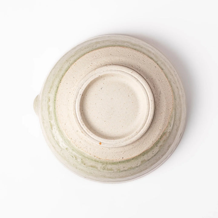 Celadon green Japanese suribachi mortar with finely grooved interior and pouring spout, perfect for grinding sesame seeds and preparing traditional sauces.
