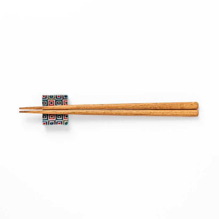 Japanese ceramic chopstick rest with colorful cobblestone mosaic pattern in red, blue, green, yellow, and black, adding elegance to any dining table.