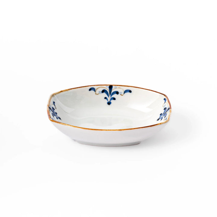 White boat-shaped bowl with blue floral patterns on the inner rim and a rustic brown edge, perfect for cereal or side dishes.