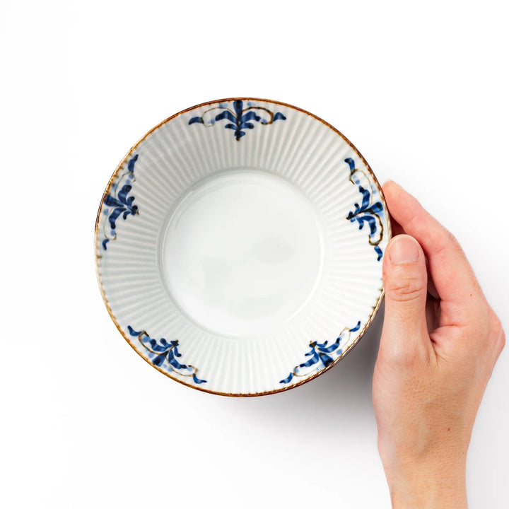 Ridged white bowl with blue floral designs around the inner rim and a brown edge, perfect for cereal, soup, or salad.
