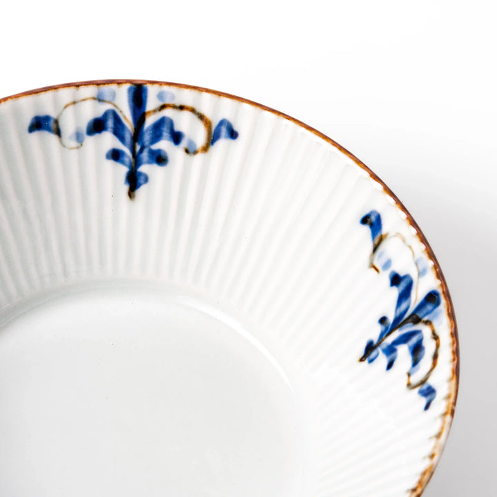 Ridged white bowl with blue floral designs around the inner rim and a brown edge, perfect for cereal, soup, or salad.