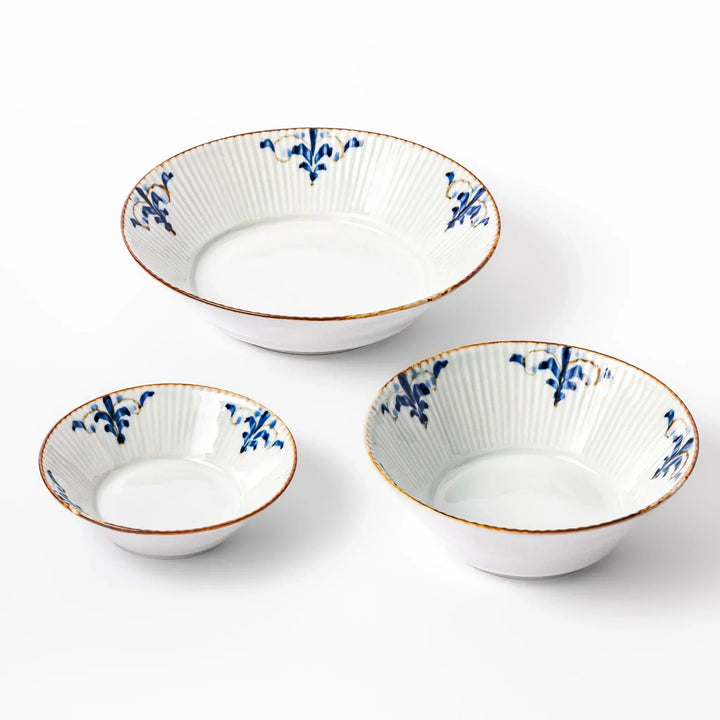 Set of three white ridged bowls with blue floral accents and brown trim, ideal for cereal, salad, or side dishes.