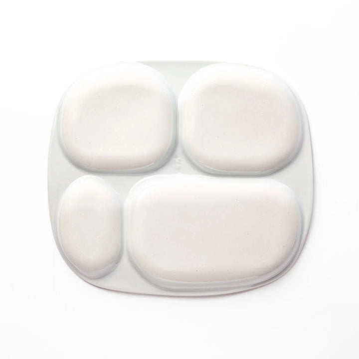 White ceramic kids plate with four divided sections, decorated with pink, yellow, red, and purple flower motifs