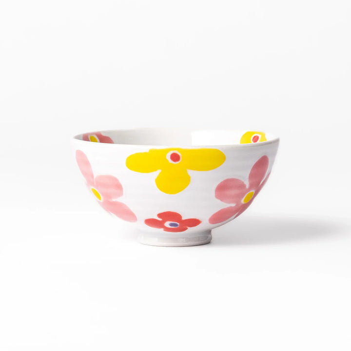 White ceramic kids rice bowl with pink, yellow, red, and purple flower motifs, round footed base