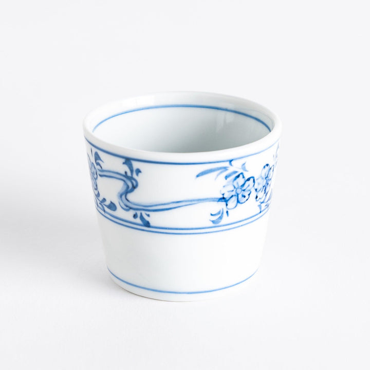 A small bowl with delicate blue floral designs flowing along the surface, perfect for condiments or small servings.