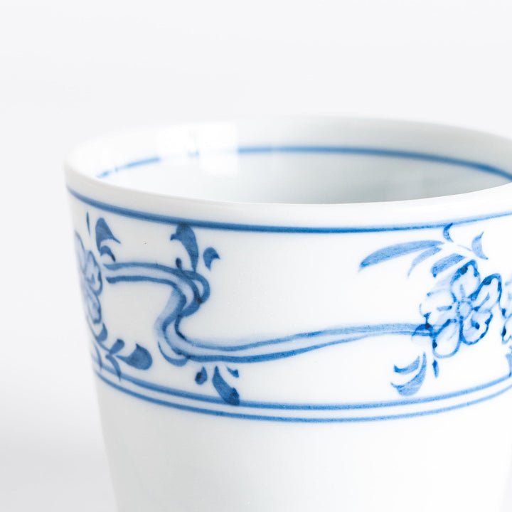 A small bowl with delicate blue floral designs flowing along the surface, perfect for condiments or small servings.