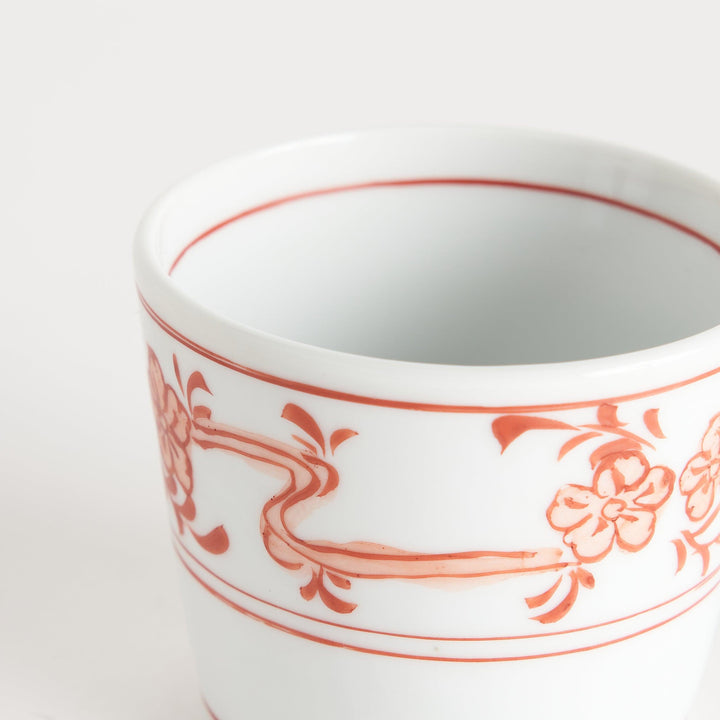 A small bowl with delicate blue floral designs flowing along the surface, perfect for condiments or small servings.