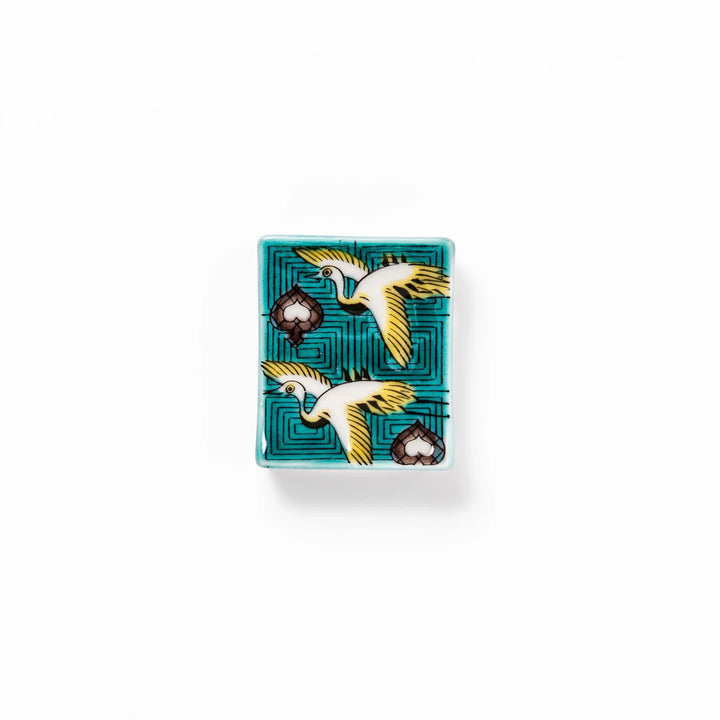 Rectangular Japanese ceramic chopstick rest featuring flying crane motif with teal geometric background and gold accents, symbolizing longevity and elegance in dining.