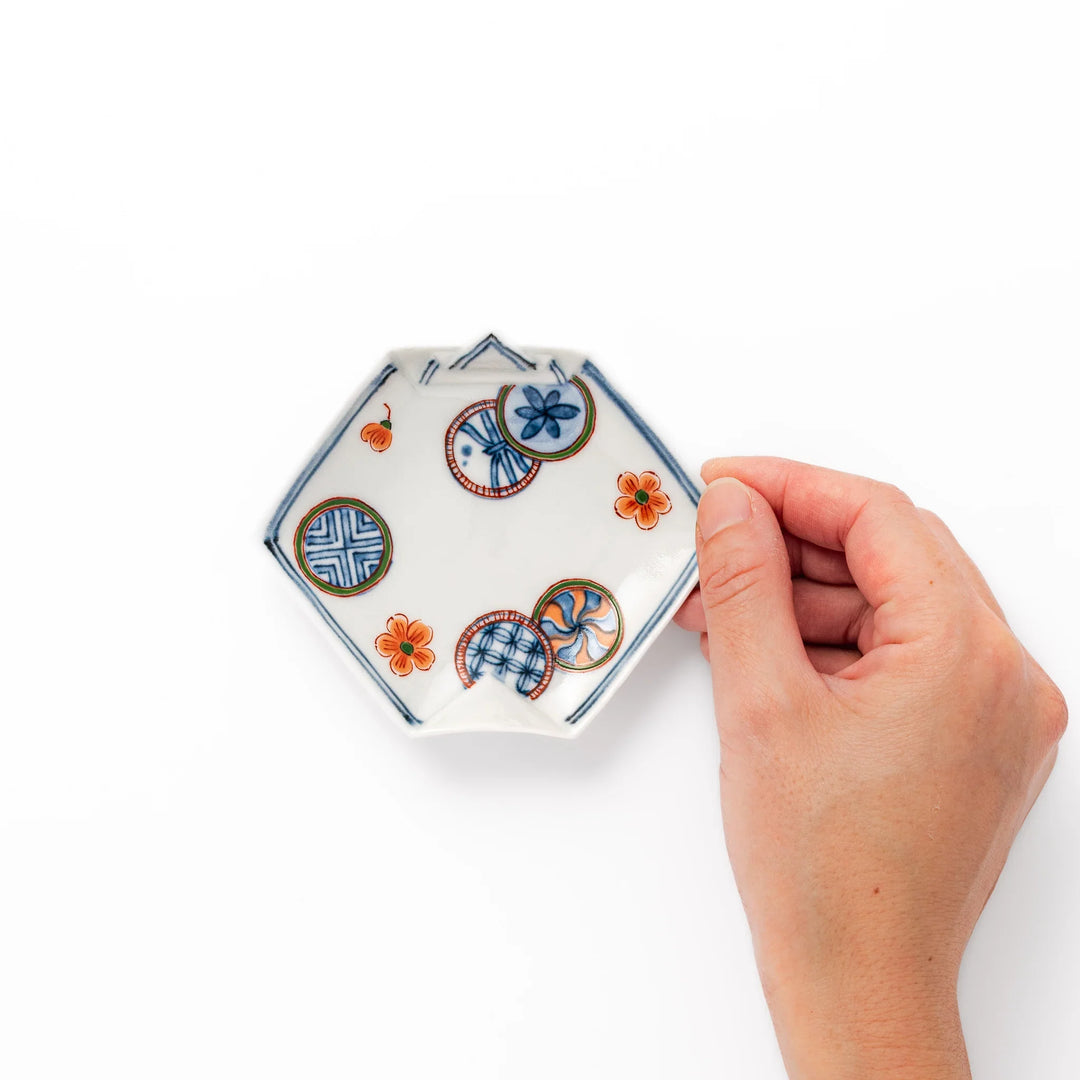 Japanese porcelain origami-shaped sauce dish with geometric circle and floral motifs, handcrafted in Japan for soy sauce, condiments, or appetizers