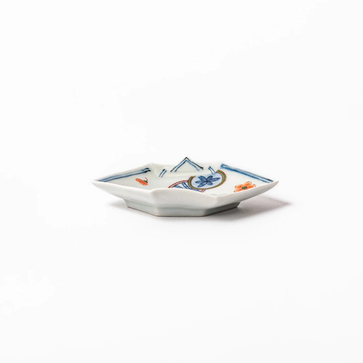 Japanese porcelain origami-shaped sauce dish with geometric circle and floral motifs, handcrafted in Japan for soy sauce, condiments, or appetizers