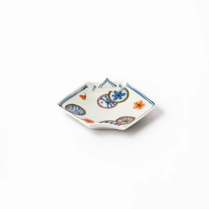 Japanese porcelain origami-shaped sauce dish with geometric circle and floral motifs, handcrafted in Japan for soy sauce, condiments, or appetizers
