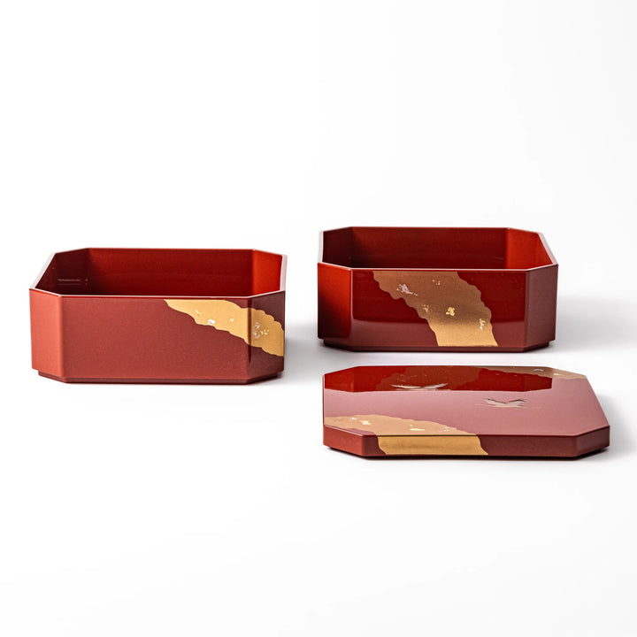 Gold River & Crane Japanese Jubako Box in hexagonal form with gold river and crane motif on vermilion red lacquer, perfect for festive food presentation.