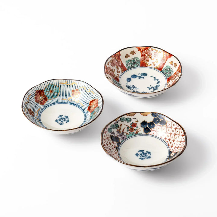 Set of three scalloped Japanese dessert bowls featuring traditional patterns in red, blue, and gold, ideal for sweets or side dishes with timeless charm.