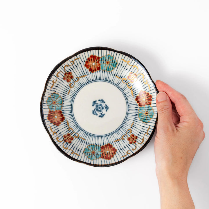 Scalloped Japanese dessert plate with vertical blue stripes and red, teal, and gold floral accents, perfect for serving sweets or small treats in style.