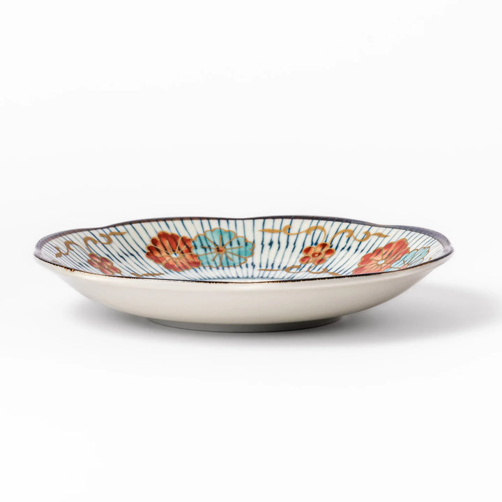 Scalloped Japanese dessert plate with vertical blue stripes and red, teal, and gold floral accents, perfect for serving sweets or small treats in style.