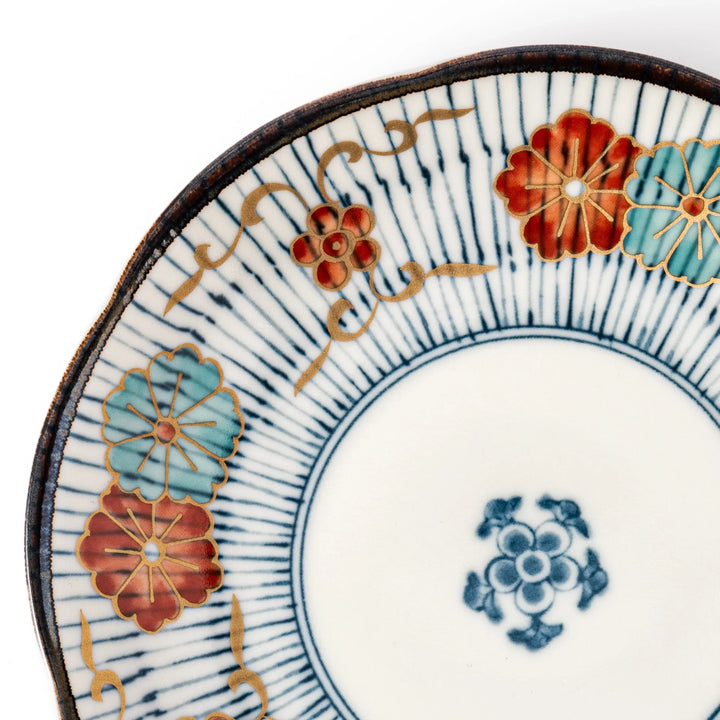 Scalloped Japanese dessert plate with vertical blue stripes and red, teal, and gold floral accents, perfect for serving sweets or small treats in style.