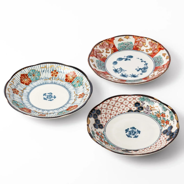 Set of three scalloped Japanese dessert plates featuring traditional patterns in red, blue, and gold, perfect for elegant sweets or small appetizers.