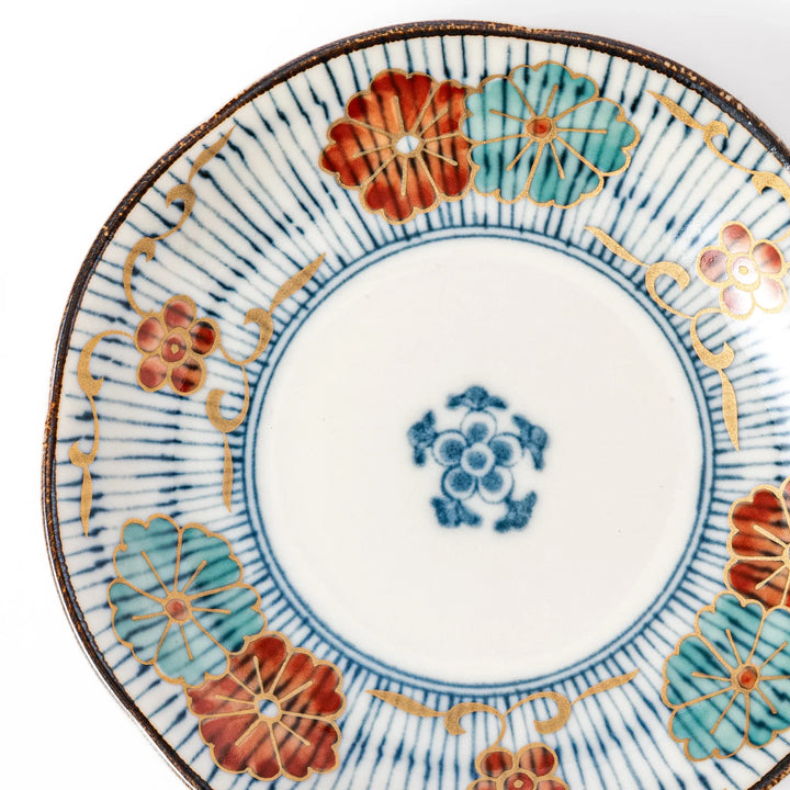 Scalloped edge Japanese sauce dish with vertical blue stripes and red, teal, and gold floral motifs, ideal for serving condiments with elegance.