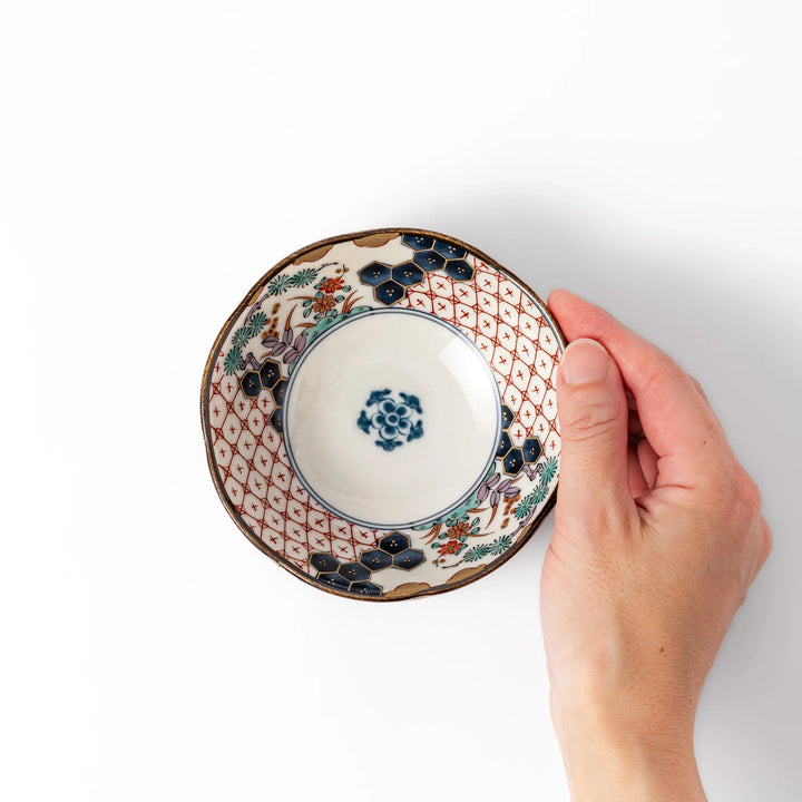 Scalloped Japanese dessert bowl with vibrant floral designs, red lattice, and navy hexagon accents, perfect for traditional sweets or small side dishes.