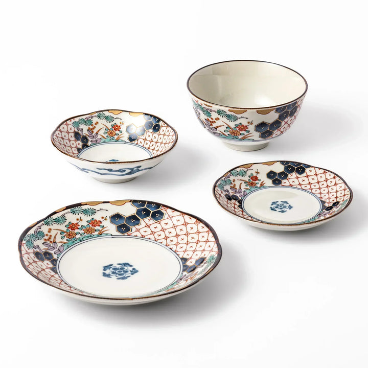 Set of traditional Japanese tableware with red lattice, navy hexagons, and floral motifs, including bowls and plates perfect for elegant everyday dining.