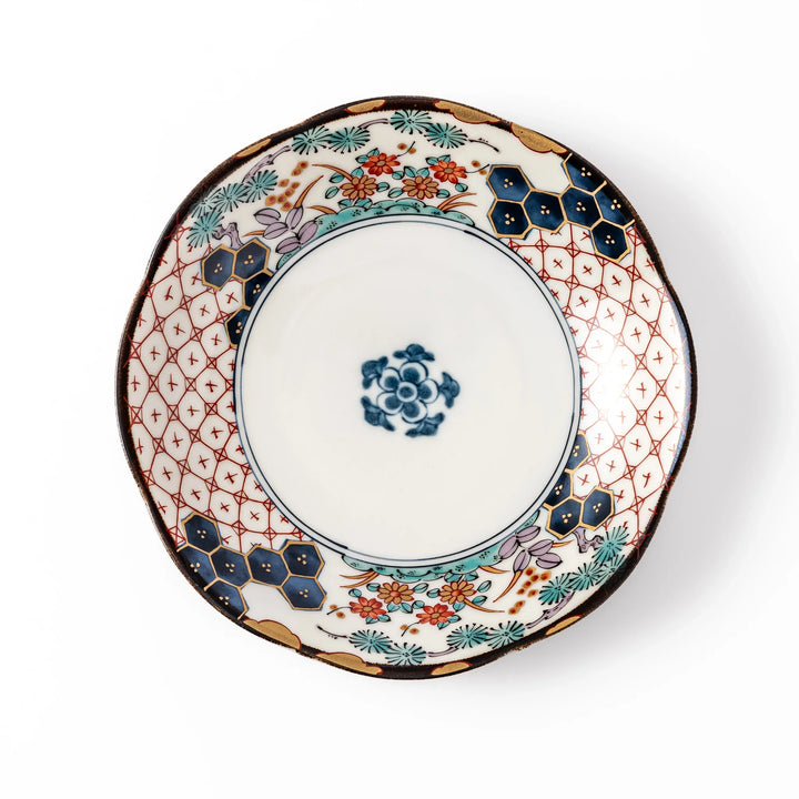 Scalloped Japanese dessert plate with red lattice, navy hexagons, and multicolor floral design, perfect for adding charm to elegant table settings.