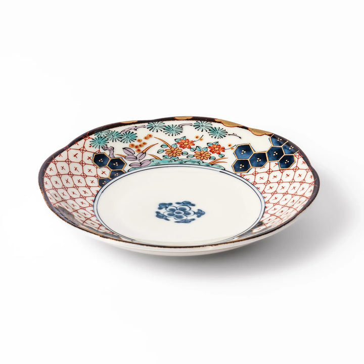 Scalloped Japanese dessert plate with red lattice, navy hexagons, and multicolor floral design, perfect for adding charm to elegant table settings.