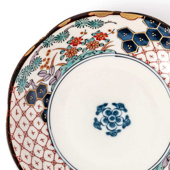 Scalloped Japanese dessert plate with red lattice, navy hexagons, and multicolor floral design, perfect for adding charm to elegant table settings.