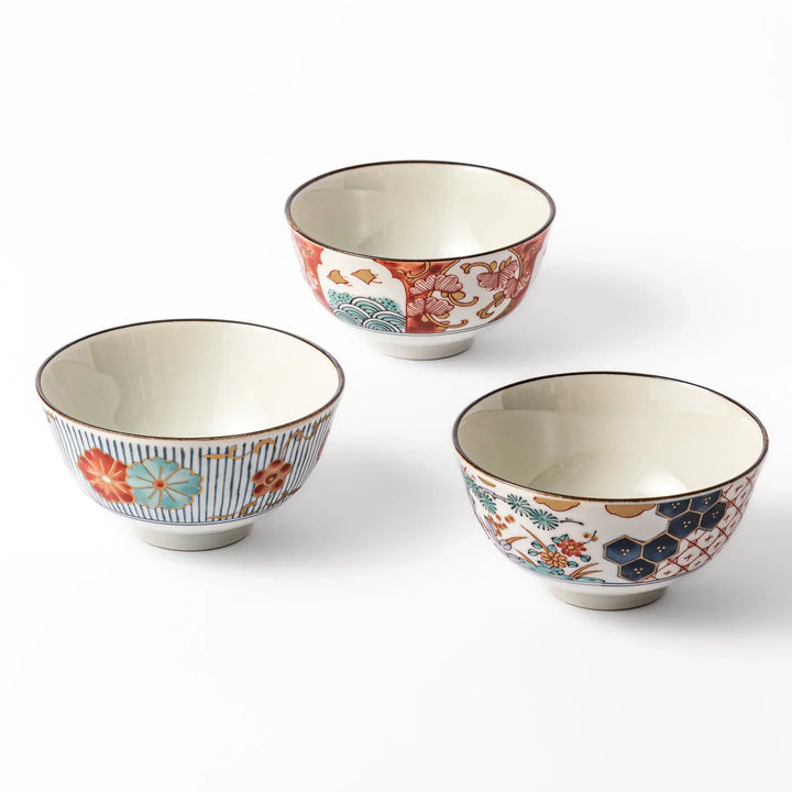Set of three traditional Japanese rice bowls with colorful patterns including florals, waves, and geometric motifs, perfect for vibrant, elegant meals.