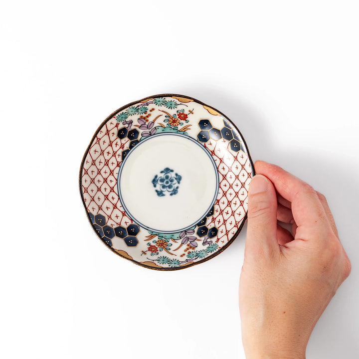 Scalloped Japanese sauce dish with red lattice, floral motifs, and navy hexagon accents, perfect for adding charm to traditional table settings.