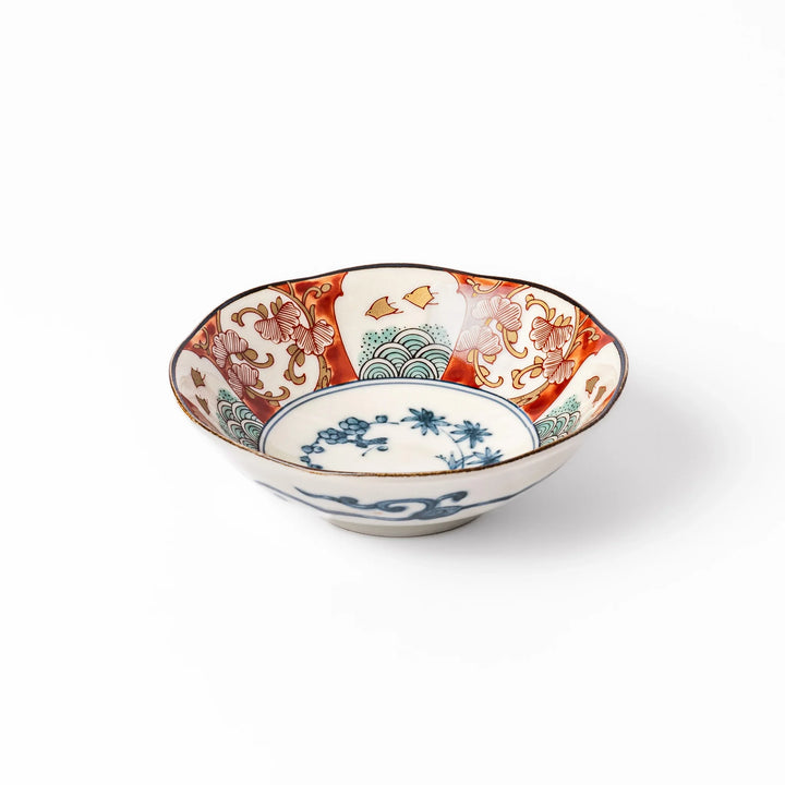 Scalloped Japanese dessert bowl with vibrant red, green, and gold patterns and a blue floral center, ideal for elegant traditional table settings.
