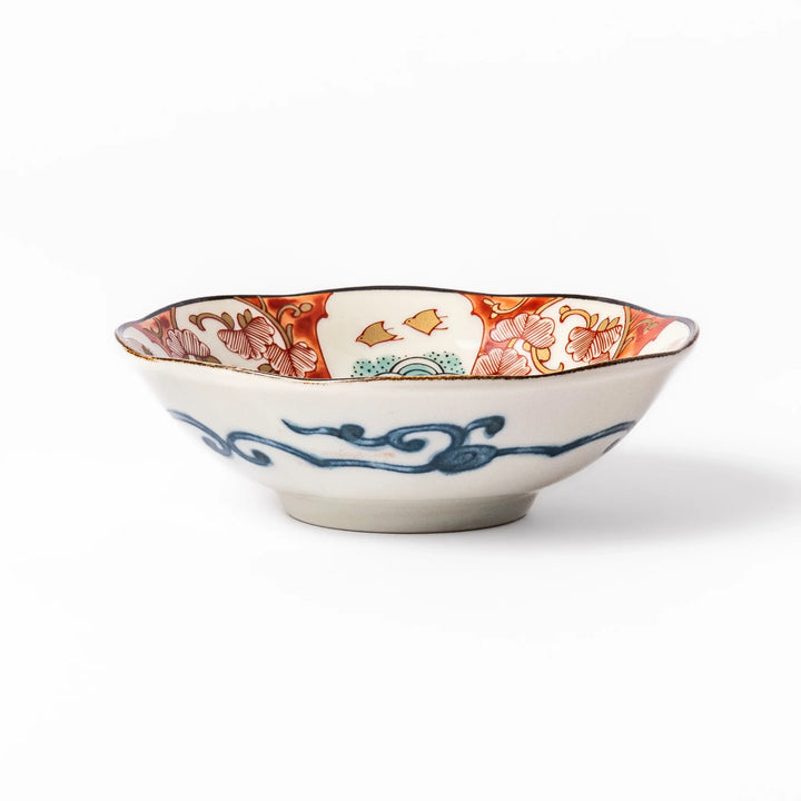 Scalloped Japanese dessert bowl with vibrant red, green, and gold patterns and a blue floral center, ideal for elegant traditional table settings.