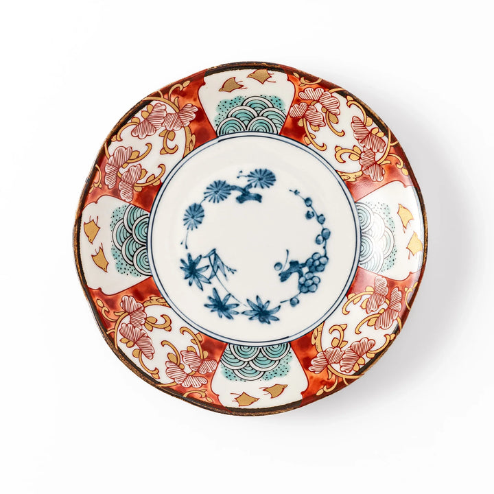 Elegant Japanese dessert plate with a scalloped edge, blue floral center, and red, gold, and green traditional patterns perfect for refined table settings.