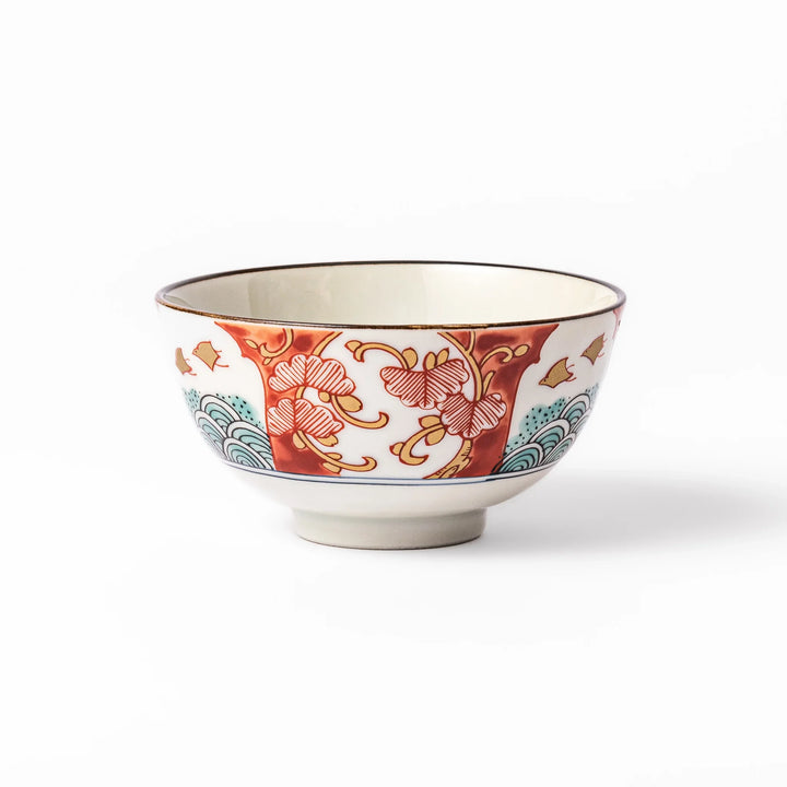 Traditional Japanese rice bowl featuring red, green, and gold motifs with waves, florals, and flying birds—perfect for refined, elegant dining.
