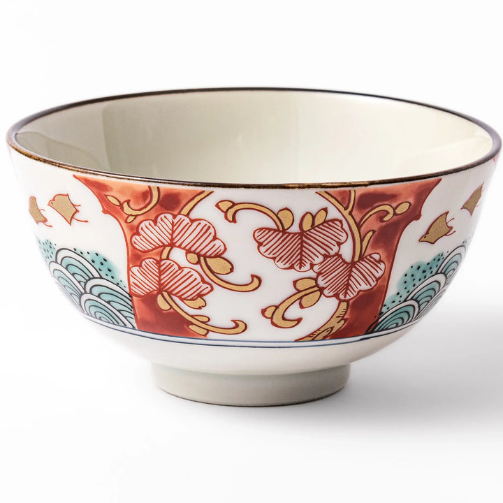 Traditional Japanese rice bowl featuring red, green, and gold motifs with waves, florals, and flying birds—perfect for refined, elegant dining.