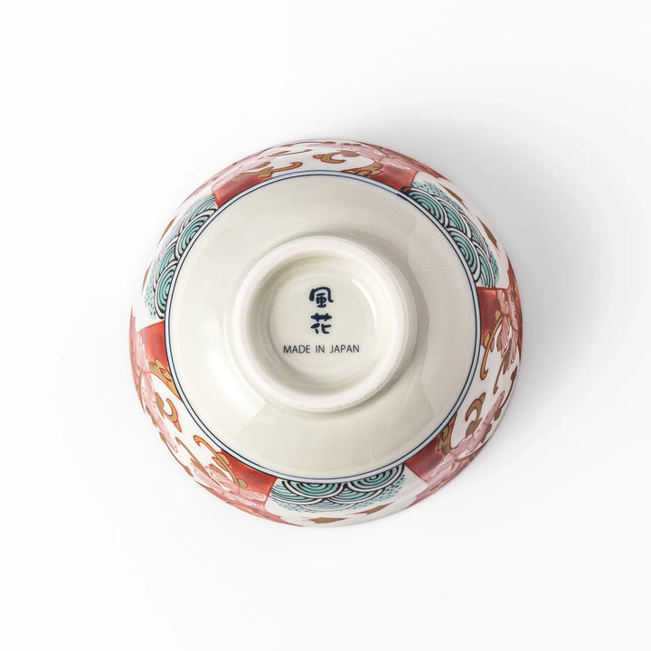 Traditional Japanese rice bowl featuring red, green, and gold motifs with waves, florals, and flying birds—perfect for refined, elegant dining.