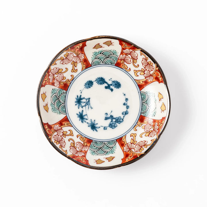 Scalloped edge sauce dish featuring red, blue, and green traditional Japanese motifs with a floral center, perfect for elegant table presentations.
