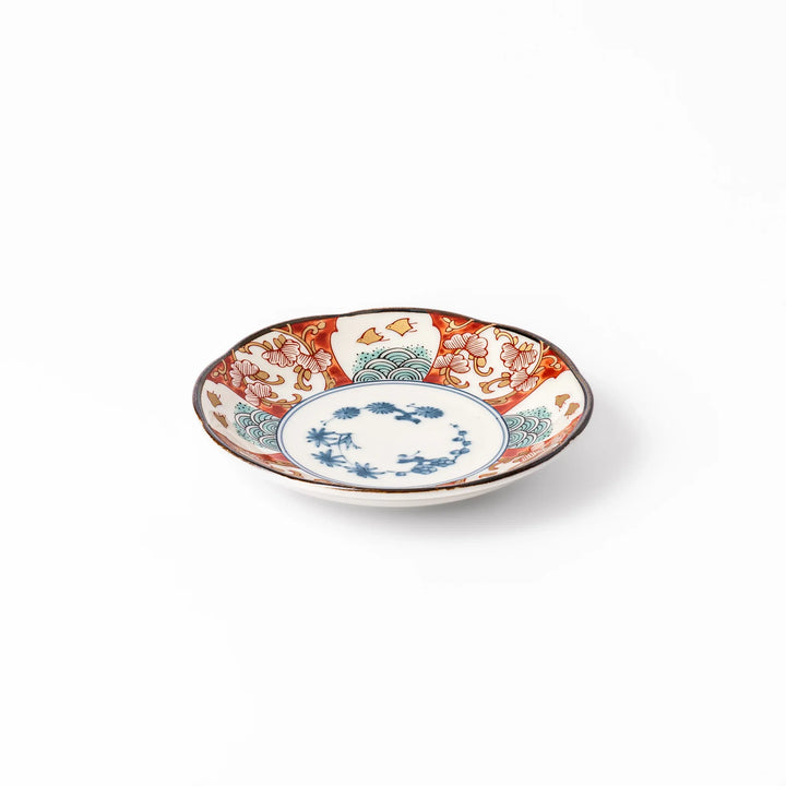 Scalloped edge sauce dish featuring red, blue, and green traditional Japanese motifs with a floral center, perfect for elegant table presentations.