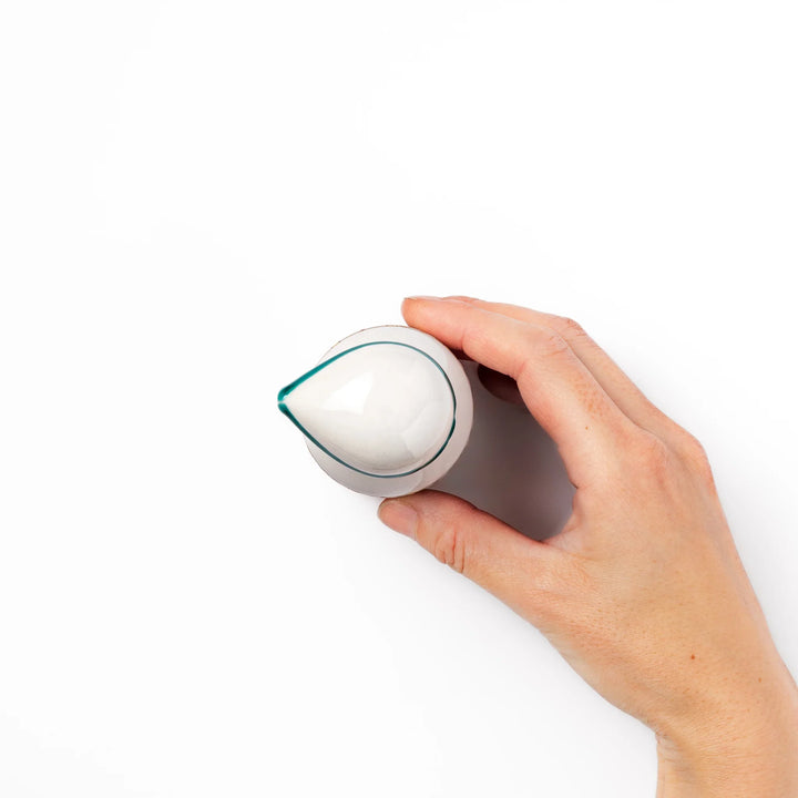 Japanese ceramic soy sauce dispenser with elegant geometric blossom pattern in teal, gold, and red accents, adding a refined traditional touch to dining tables.