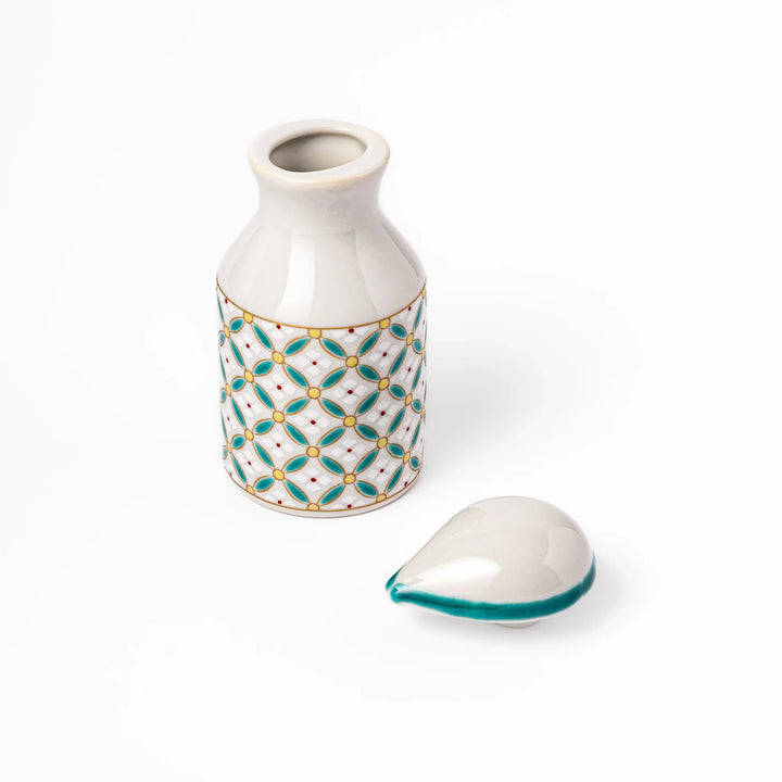 Japanese ceramic soy sauce dispenser with elegant geometric blossom pattern in teal, gold, and red accents, adding a refined traditional touch to dining tables.