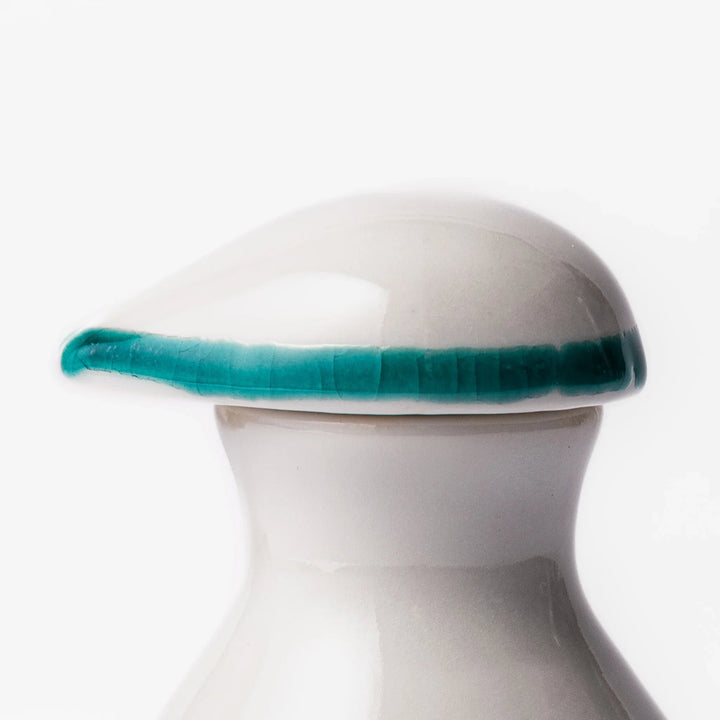 Japanese ceramic soy sauce dispenser with elegant geometric blossom pattern in teal, gold, and red accents, adding a refined traditional touch to dining tables.