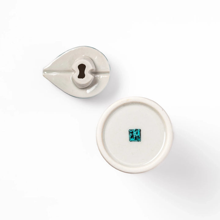 Japanese ceramic soy sauce dispenser with elegant geometric blossom pattern in teal, gold, and red accents, adding a refined traditional touch to dining tables.