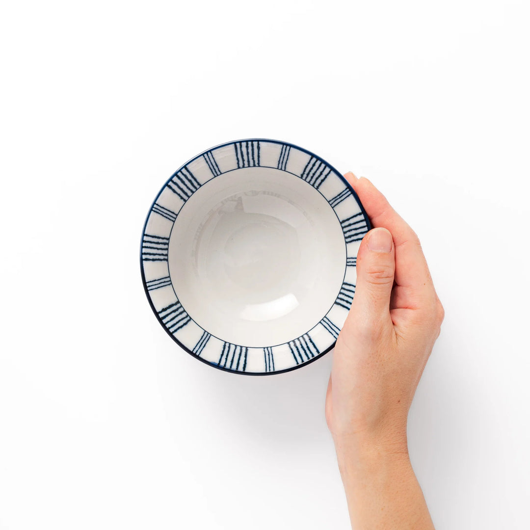 Japanese porcelain rice bowl with fine indigo vertical stripes and natural terracotta base, handcrafted in classic minimalist style.