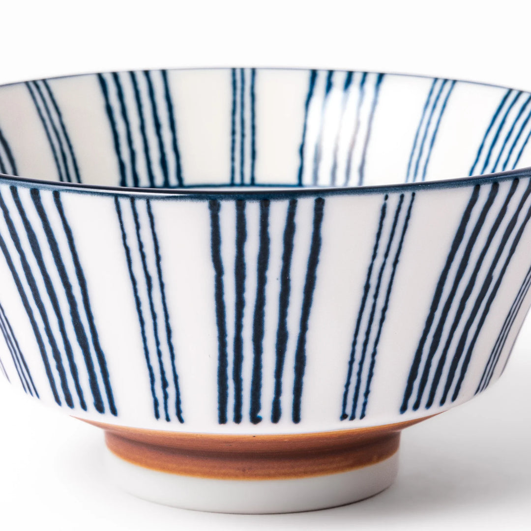 Japanese porcelain rice bowl with fine indigo vertical stripes and natural terracotta base, handcrafted in classic minimalist style.