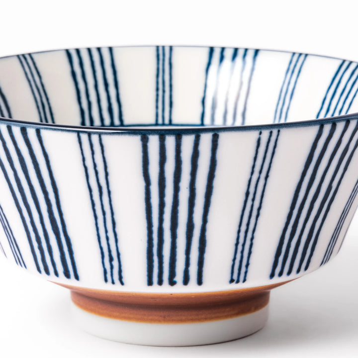 Japanese porcelain rice bowl with fine indigo vertical stripes and natural terracotta base, handcrafted in classic minimalist style.